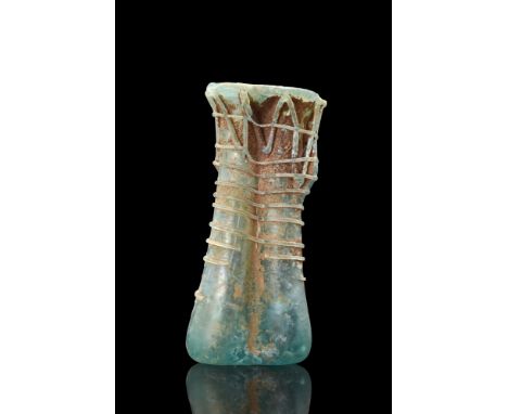 Ca. 300-400 AD. A beautiful double balsamarium crafted from blue glass. The vessel is composed of two conjoined tubular phial