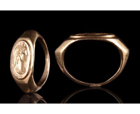 Ca. 100-300 AD. A beautifully formed one-piece gold ring with broad shoulders tapering into the band and a large bezel finely