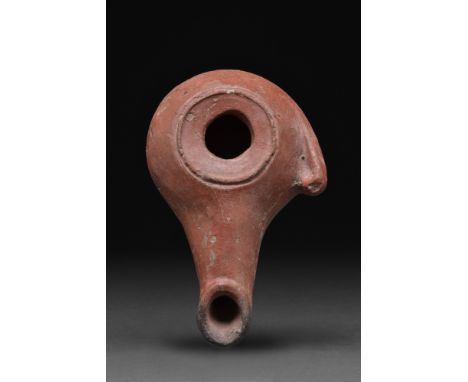 Ca. 1st century BC - 1st century AD. A terracotta oil lamp with a round upper body with inward-sloping discus and a filling h