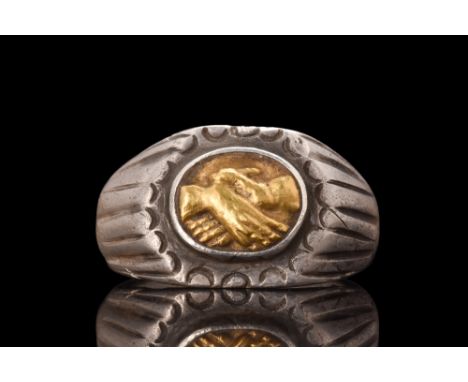 Ca. 100-300 AD. A massive silver ring is composed of a wide hoop that expands at the shoulders to form a flat bezel, which is