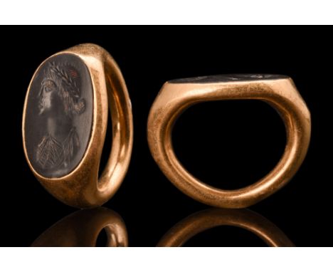 Ca. 100-200 AD. An oval-shaped jasper intaglio featuring a meticulously crafted left-facing young female portrait. The woman'