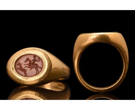 Ca. 100-300 AD. A rare gold, heavy signet ring composed of a round, flat-section hoop with expanded and carinated shoulders; 