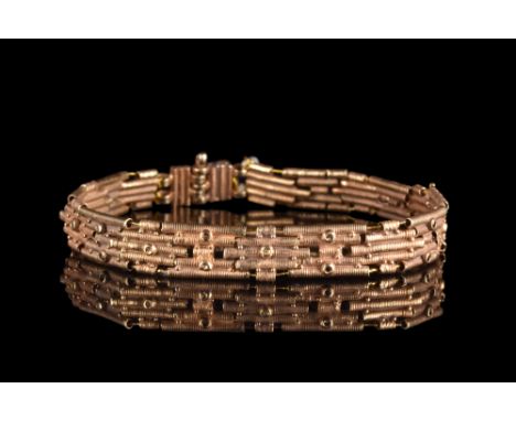 Ca. 300 BC. A stunning bracelet composed of gold coiled tubes woven together with gold wire and secured with a pin. The brace