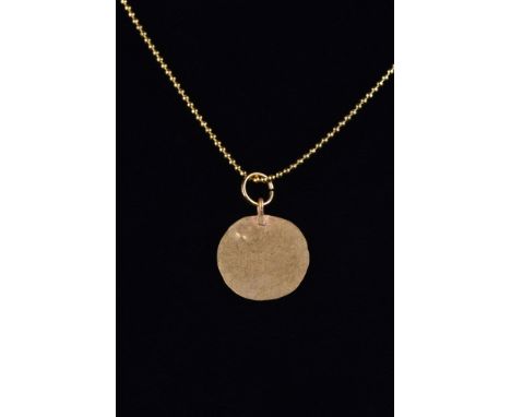 Ca. 200-300 AD. A finely rendered gold disc-shaped pendant, hammered from thin gold with a suspension loop. This piece is ful