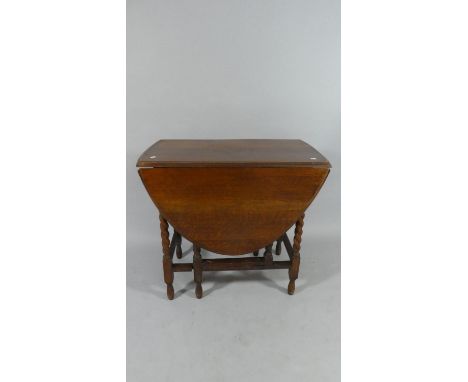 An Oak Oval Topped Drop Leaf Gate Legged Barley Twist Table, 79cm Long 