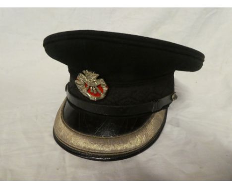 A green cloth Officers peaked cap of the Duke of Cornwall's Light Infantry with silver plated cap badge and silver wire mount