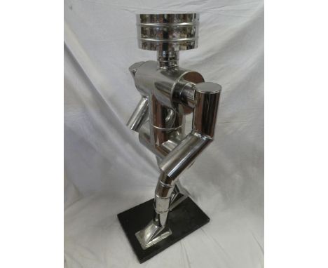 An unusual 1960's stainless steel commercial display figure modelled as a walking robot and constructed from exhaust parts, o