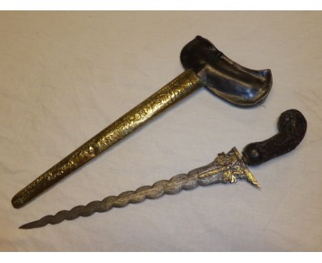 An old Eastern Kris dagger with 12½" watered steel wavy blade, carved wood hilt in brass mounted wood scabbard