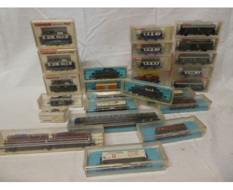 Three Fleischmann Piccolo electric locomotives and a selection of boxed carriages together with an Atlas N gauge boxed locomo