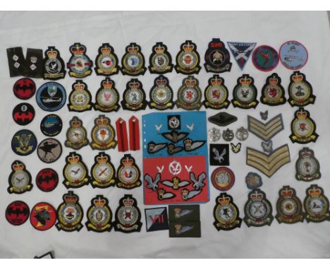 A collection of Army Air Corps badges and insignia including embroidered wire Pilots wings, Gunner &amp; Observers wings, clo