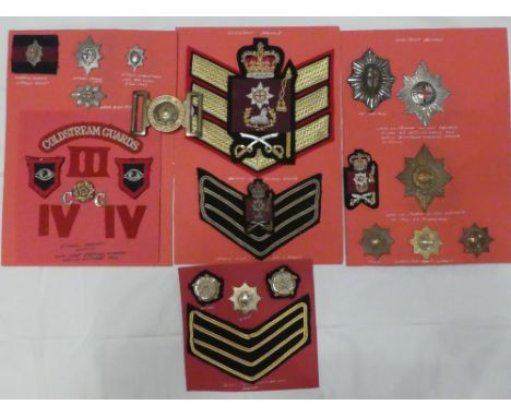 A collection of Coldstream Guards badges and insignia including Victorian embroidered wire sash badge, Foreign Service helmet