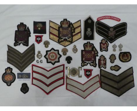 A collection of Grenadier Guards badges and insignia including Officers embroidered wire cap badge and collars, Warrant Offic