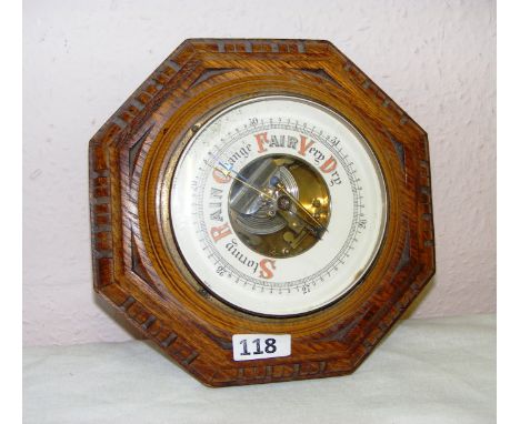 A mid 20th century circular oak wall barometer measuring 9" in diameter. CONDITION REPORT: Good cosmetic condition.