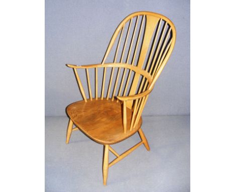 A mid 20th century blonde Ercol arm chair, labeled to the reverse and measuring 23" wide. CONDITION REPORT: In good clean con