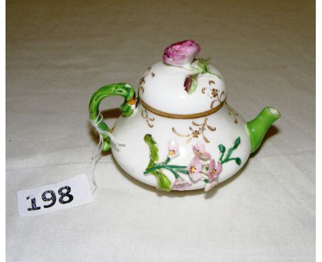 A late 19th century English porcelain miniature teapot, in the Coalbrookedale style, encrusted with flowers, measuring 2" tal