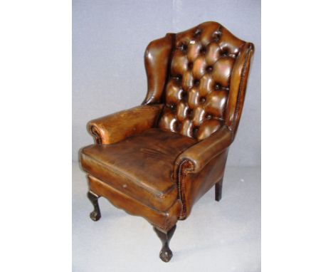 A mid 20th century oxblood Chesterfield style button back arm chair, standing on claw feet and measuring 27" wide. CONDITION 