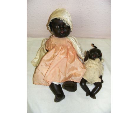 Two Vintage Black baby dolls by Reliable Canada, both circa 1950's the largest at 15" long. CONDITION REPORT: Each in good co