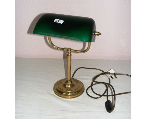A vintage brass reading lamp with a green glass shade, measuring 14.5" tall. CONDITION REPORT: In good condition.