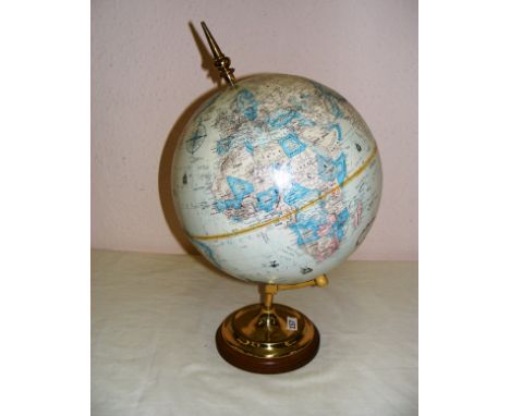 A vintage globe standing on a wooden base and brass bracket measuring 20" tall. CONDITION REPORT: Good condition.