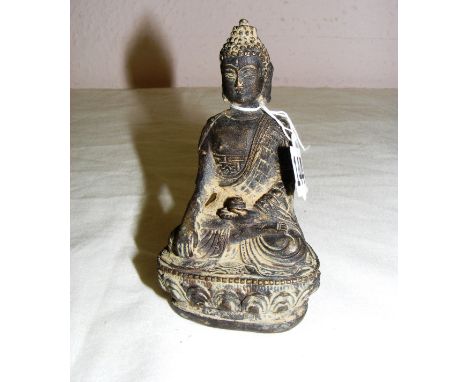 A small Chinese metal Buddha statue, measuring 4" tall. CONDITION REPORT: Good condition.