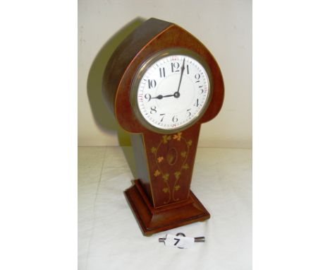 An Edwardian mahogany inlaid tulip mantle clock on four bun feet, in working order (not checked for time keeping), measuring 