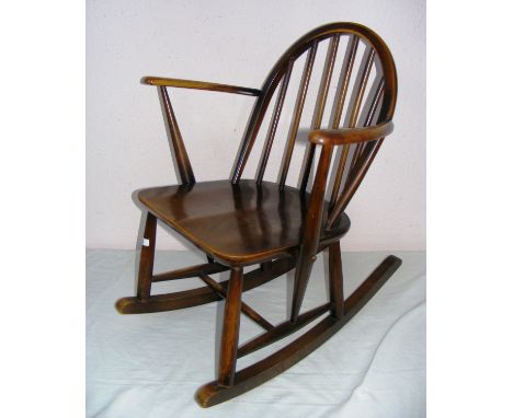 A vintage child's Ercol stick back rocking chair (with label present), measuring 28" tall. CONDITION REPORT: Good structural 