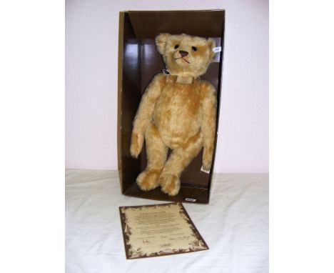 A modern Steiff 1907 replica teddy bear with certificate measuring 22" tall. CONDITION REPORT: In good condition, part boxed.