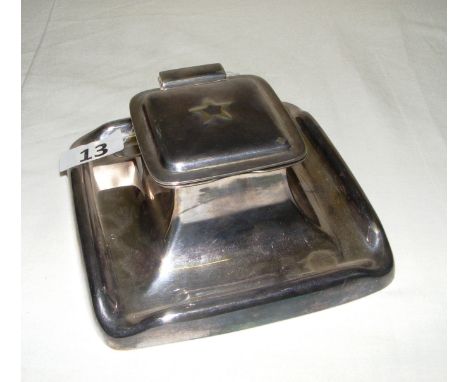A Elkington silver plated inkwell, with the star motif to the hinged lid encasing a ceramic ink liner. Various marking to the