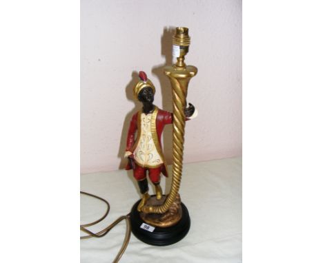 A modern resin table lamp in the form of a Blackamoor figure, signed R. Harmon 97 to the reverse and measuring 21" tall. COND