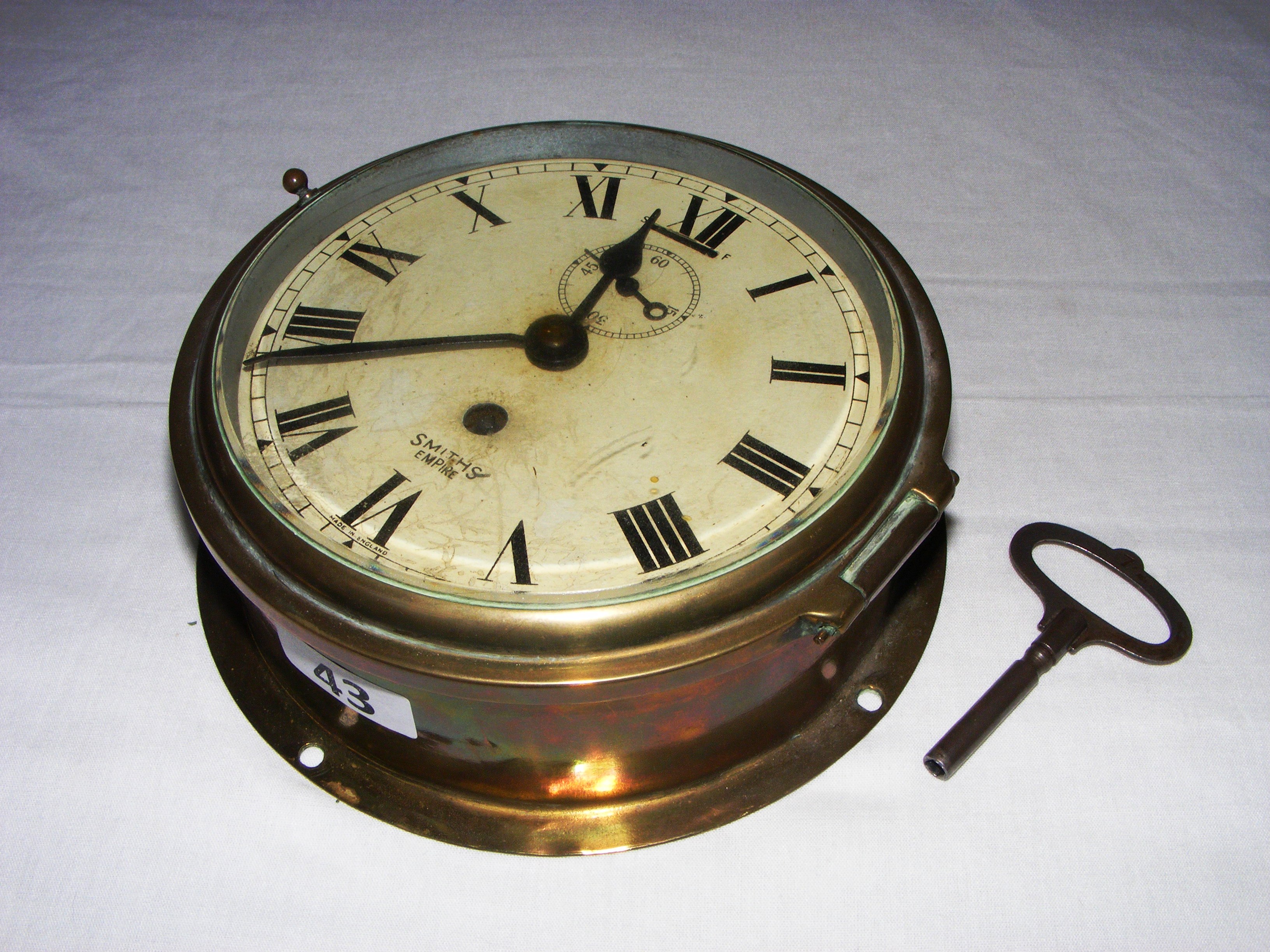 An antique Smiths Empire ships clock, in good working order with its ...