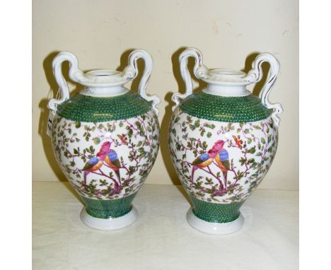A pair of continental twin handled porcelain vases, painted with birds and scales, with a Sitzendorf style crossed blue mark 