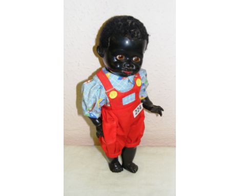 A vintage 1950's Pedigree black baby doll with voice box, 13.5" long. CONDITION REPORT: Voice not working.