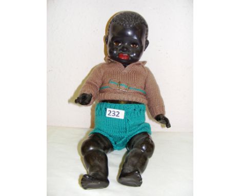 A vintage 1950's Pedigree transitional black baby doll with voice box, measuring 17" long. CONDITION REPORT: Voice box not wo