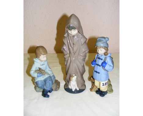 Three porcelain Nao figurines including a boy with a dog hiking, a boy seated with a rabbit and a boy in a cloak with a dog, 