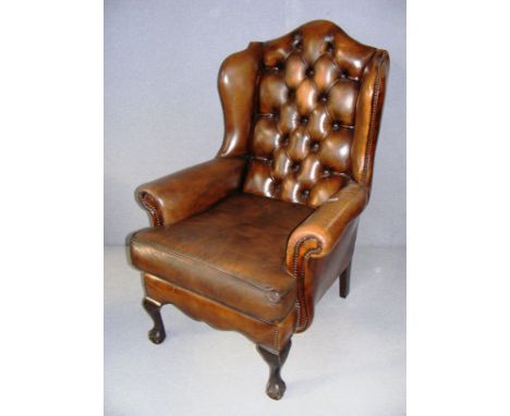 A mid 20th century oxblood Chesterfield style button back arm chair, standing on claw feet and measuring 27" wide. CONDITION 
