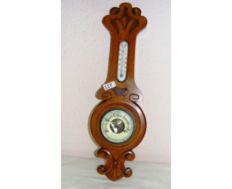 A mid 20th century oak cased banjo barometer measuring 21.5" long. CONDITION REPORT: Good condition.