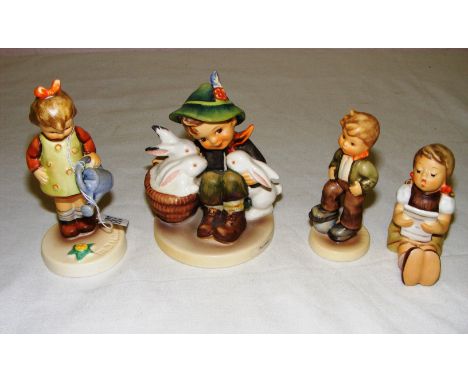 Four Goebel figurines including on titled "Playmates", "Little Gardener", "Lets Play" and a girl seated. The largest is 4.25"