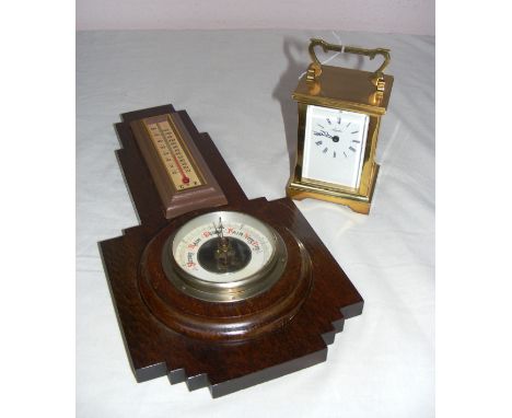 A modern brass carriage clock, the dial signed Angelus, of a good solid weight, with a battery movement and an oak cased baro
