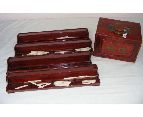 A vintage Chinese hardwood boxed games set with two trays and playing pieces.
