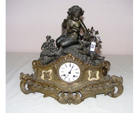 A French spelter mantle clock modelled as a cherub and animals in a Rococo manner, measuring 13.5" tall, with a bell striking