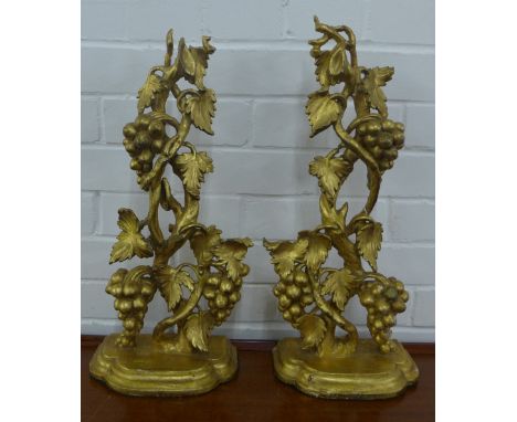 Pair of giltwood wall brackets with grape vine supports and semi circular shelf lined baize, 52cm high 