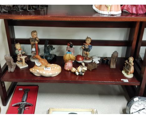 Shelf lot of various figures including Hummel