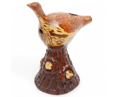 Early 19th century slipware whistle, in the form of a bird perched on a trunk, H17cm 