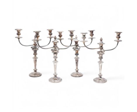Set of four silver plated three light candelabra with gadrooned borders, tapering stems and circular foot H46cm