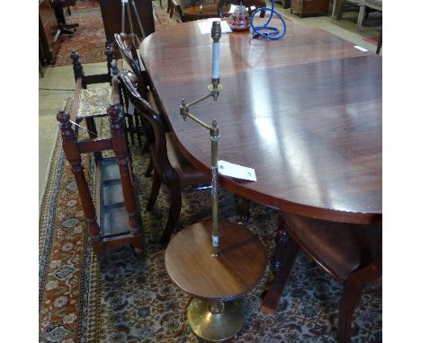 A C20th mahogany and brass standard lamp with a pleated tartan shade