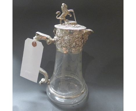 A fine silver plated mount claret jug, glass etched with vine pattern with lion finial 