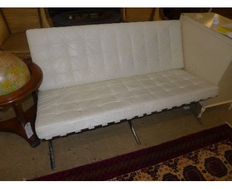 A Barcelona design two seater bench in ivory button leather on chrome supports