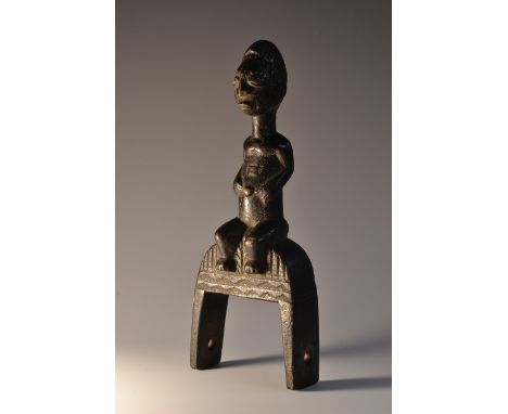 Tribal Art - an African heddle pulley figure, pregnant, seated upon a base of typical form, 20cm high