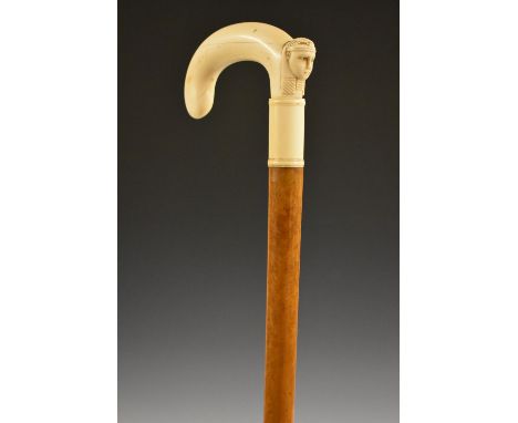 An Egyptian Revival ivory and malacca gentleman's walking stick, the crook handle carved with the profile of a pharaoh, weari