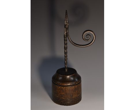 A wrought iron nip rush light holder, circular oak base, 34cm high